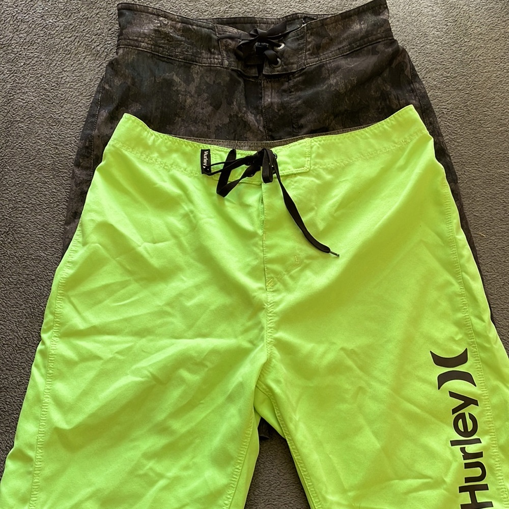 Two pair swim trunks, youth size 12. Under Armour and Hurley.